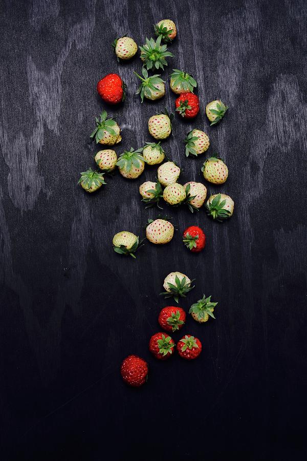 Strawberries On A Black Surface Photograph by Elli Briest