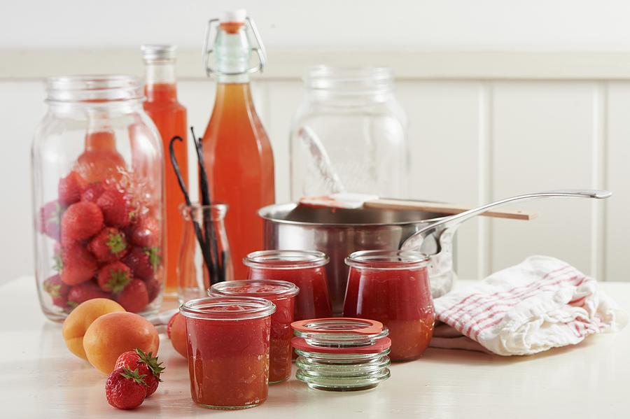 Strawberry And Apricot Jam In Glass Jars, With Fresh Apricots And Strawberries Photograph by Hannah Kompanik