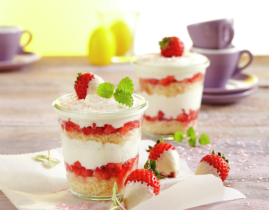 Strawberry And Yoghurt Layer Cake In Jars Decorated With White Chocolate Strawberries Photograph by Teubner Foodfoto