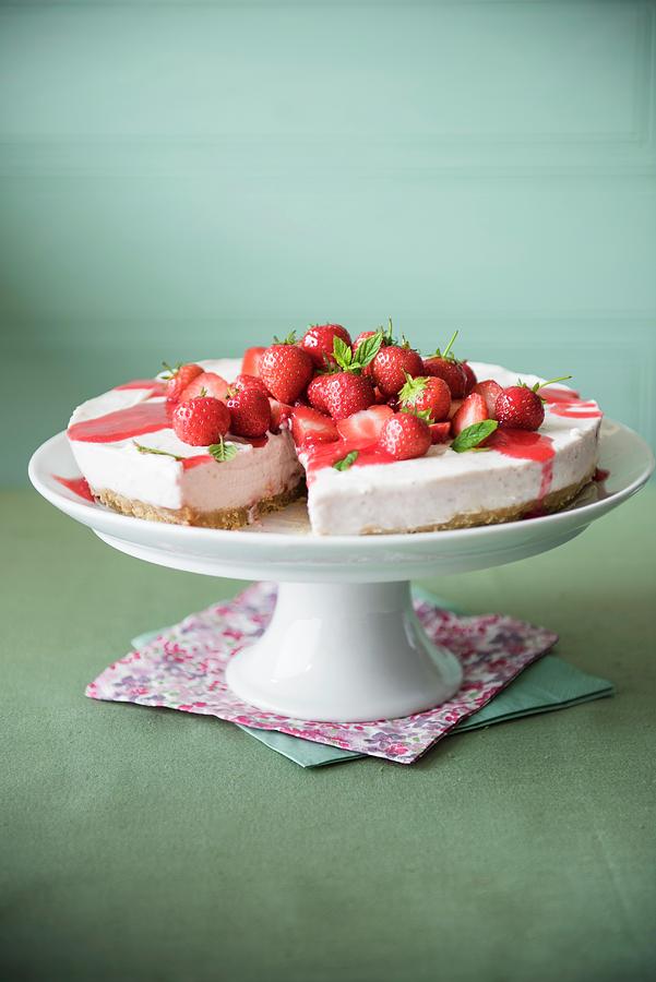 Strawberry Cheesecake With Strawberry Sauce On A Cake Stand Photograph by Magdalena Hendey