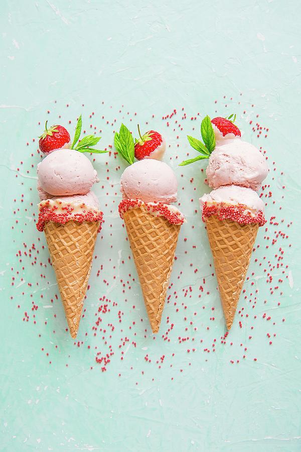 Strawberry Ice Cream In Ice Cream Cones With Sprinkles Photograph by Magdalena Hendey
