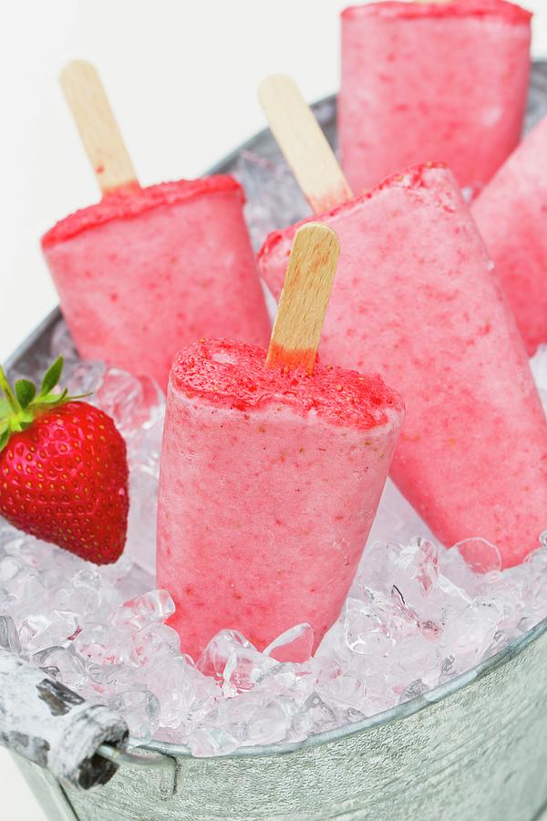 Strawberry Ice Cream Sticks On Crushed Ice In A Zinc Tub Photograph by Esther Hildebrandt