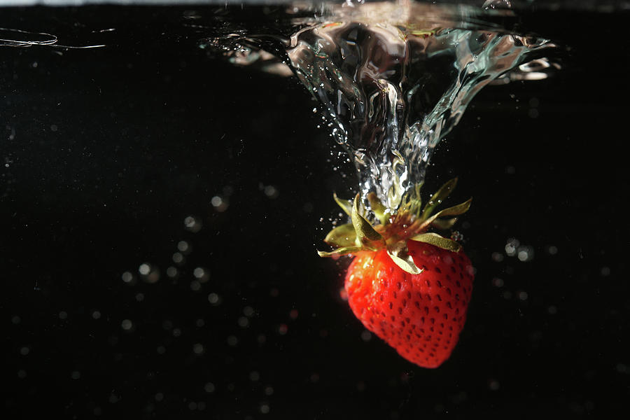 Strawberry In Water Photograph by Copyright By Patricklee