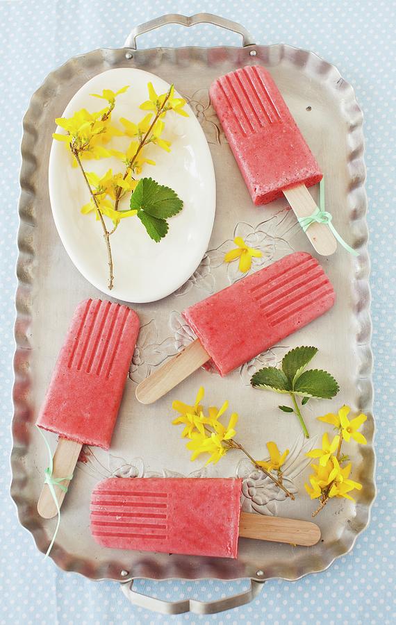 Strawberry Smoothie Ice Lollies On A Tray With Forsythia Flowers Photograph by Strokin, Yelena