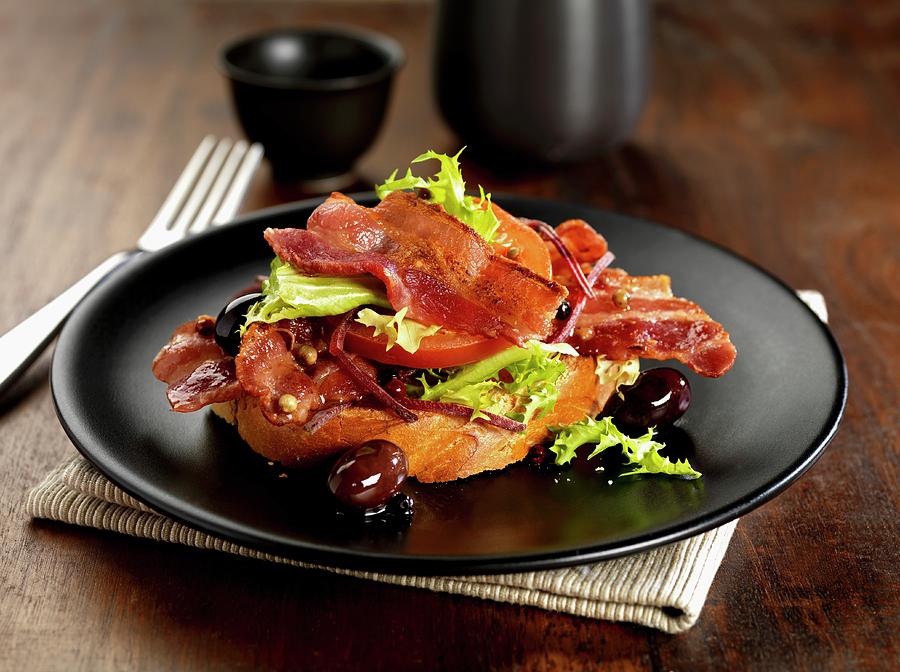 Streaky Bacon With Tomato, Lettuce, Black Olives, Peppercorns And Shredded Beetroot On Brucshetta Photograph by Robert Morris