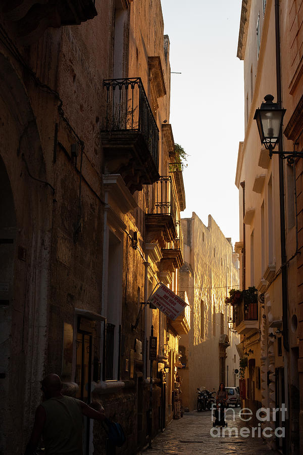 Street at sunset in Gallipoli, Italy Photograph by Patricia Hofmeester