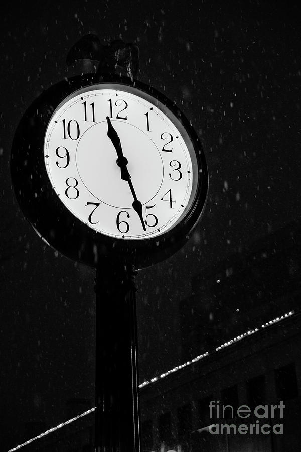 Street clock during a snowfall, time passes. Photograph by Joaquin Corbalan