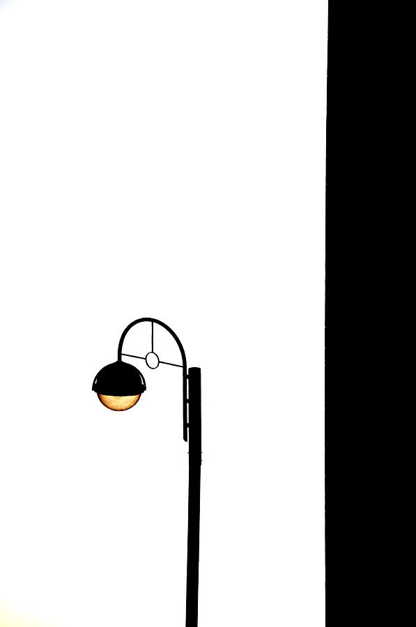 Street Lamp On White With A Black Wall Photograph by Margareta Lindeman