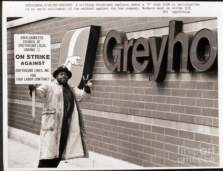 Striker Stands Beside Greyhound Sign Photograph by Bettmann