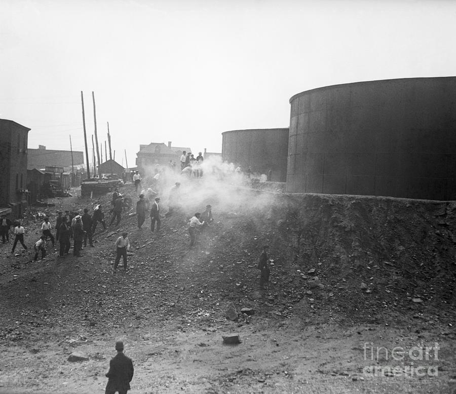 Strikers Behind Oil Tanks With Smoke Photograph by Bettmann