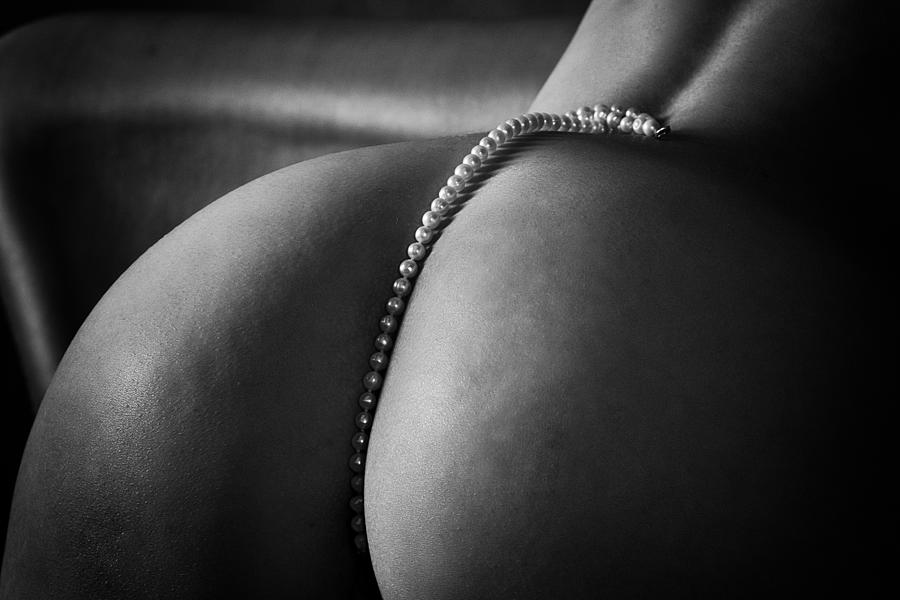 String Of Pearls Lying On A Woman\s Back And Descending Between The Buttocks Photograph by Alexandr