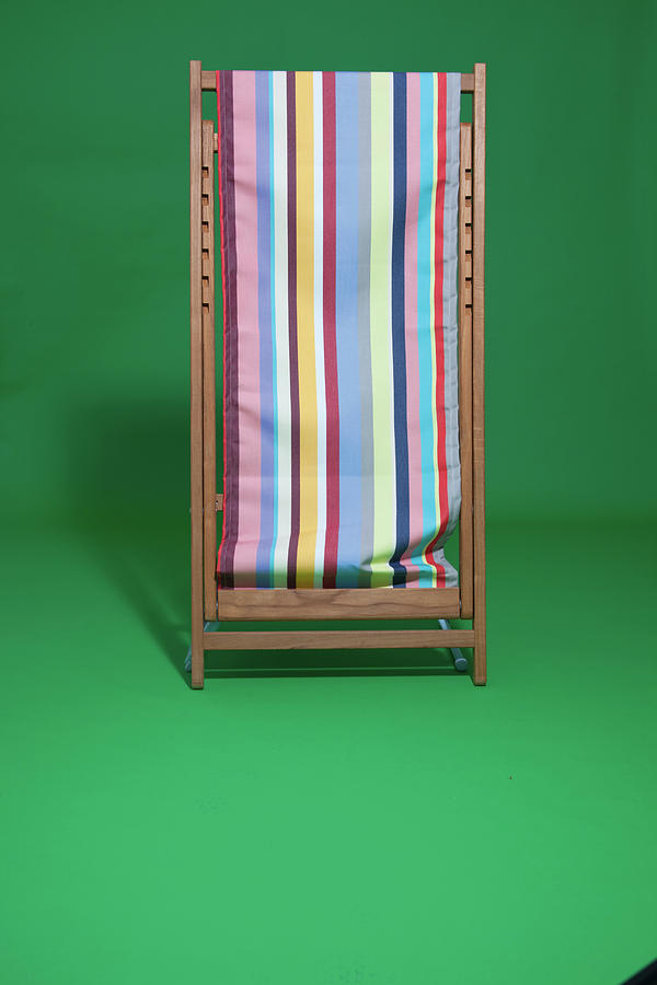 Striped Beach Chair On Green Background Photograph by Jalag / Heike Berger