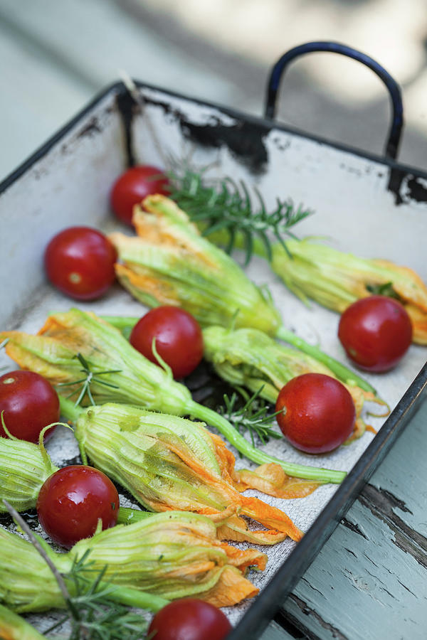 Stuffed Courgette Flowers With Cherry Tomatoes And Rosemary Photograph by Eising Studio