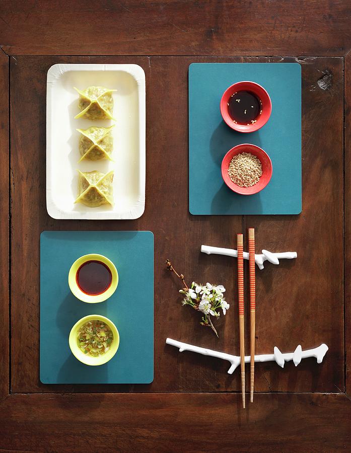Stuffed Oriental Dumplings And Small Bowls Of Various Sauces Photograph by Anderson Karl