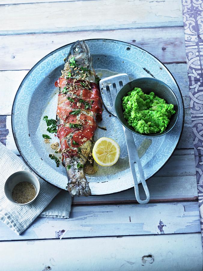 Stuffed Trout Wrapped In Ham With Sesame Seed Butter And Mushy Peas And Parsnips Photograph by Jalag / Wolfgang Kowall