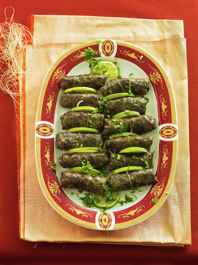 Stuffed Vine Leaves With Sliced Lime Photograph by Andreas Thumm