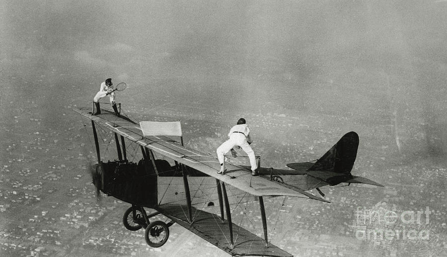 Stunt Flyers Performing On Wings Photograph by Bettmann