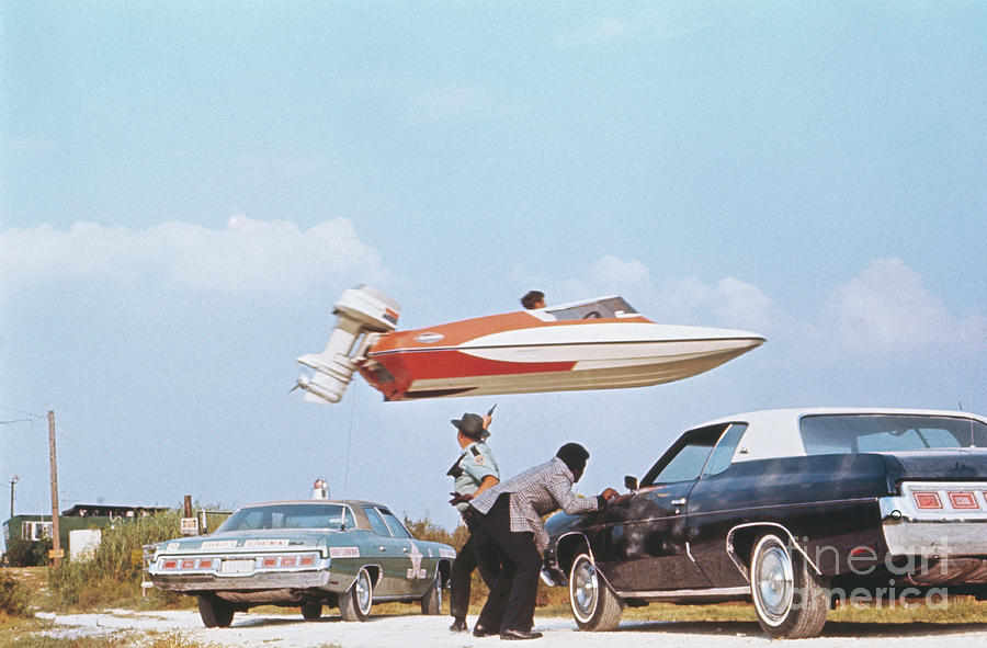 Stuntman Jumping A Speedboat Over Cars Photograph by Bettmann