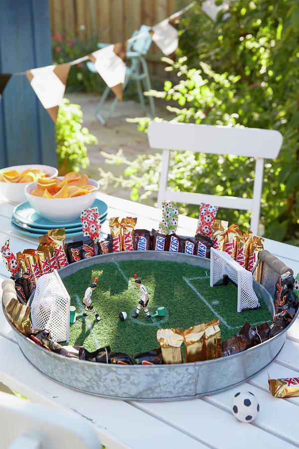 Stylised Football Pitch On Metal Tray With Artificial Grass And Toy Figurines As Table Decoration For Football-themed Party Photograph by Jalag / Olaf Szczepaniak