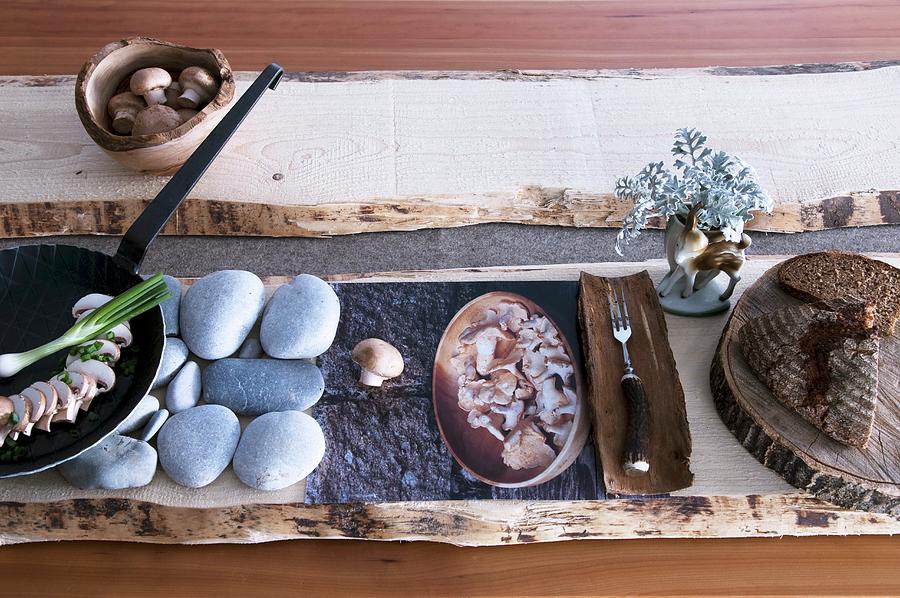 Stylised Meal Of Mushrooms And Bread With Rustic Ornaments Of Wood And Stone Photograph by Matteo Manduzio