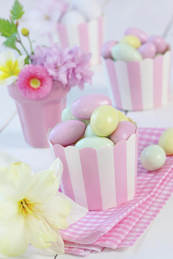 Sugar Eggs In Paper Cupcake Holders Next To Narcissus Flower Photograph by Angelica Linnhoff