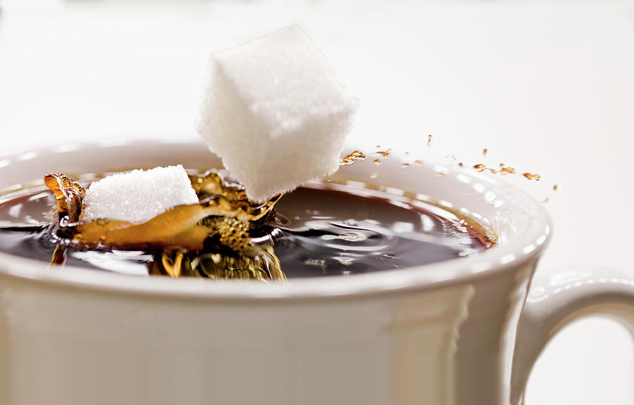 Sugar Lumps Falling Into A Cup Of Coffee Photograph by Jim Scherer