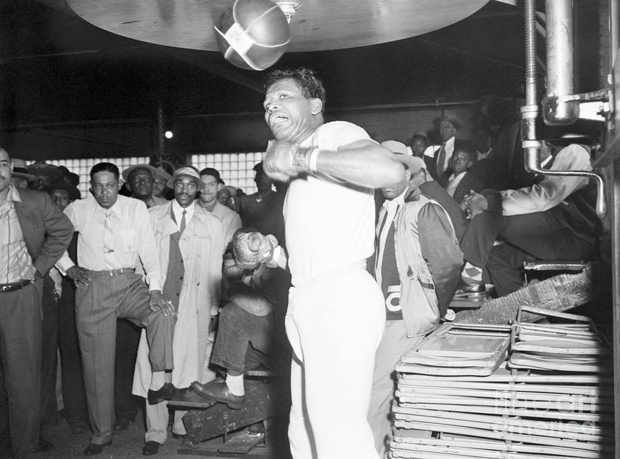 Sugar Ray Robinson Punching Bag Photograph by Bettmann
