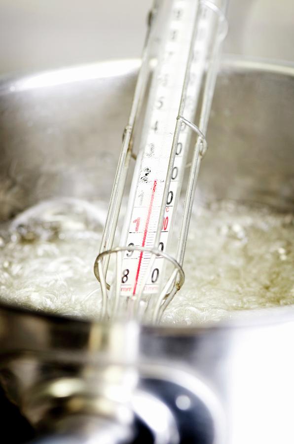 Sugar Syrup Being Boiled With A Sugar Thermometer Photograph by Jamie Watson