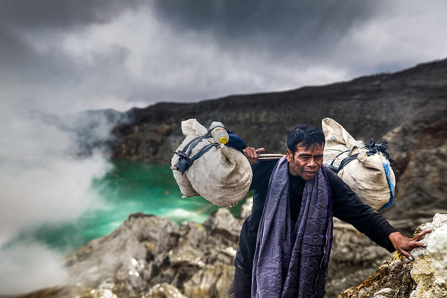 Street Photograph - Sulphur Miner In Ijen Volcano by Francisco Mendoza Ruiz