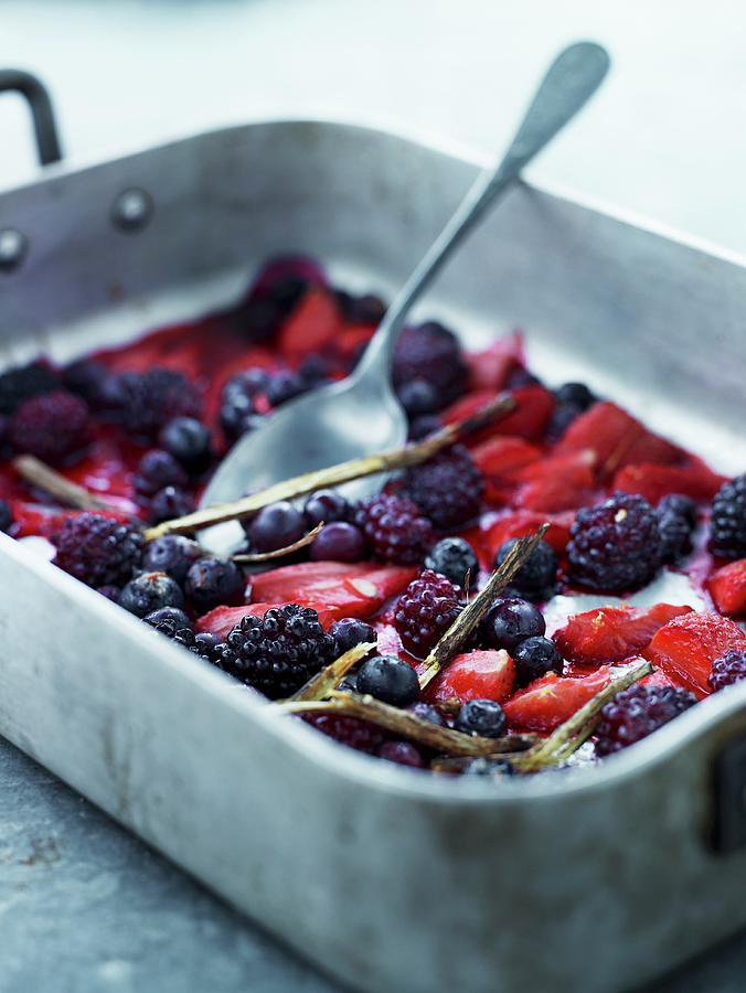 Summer Berries With Liquorice, Lemon And Cane Sugar In A Baking Tin Photograph by Lars Ranek