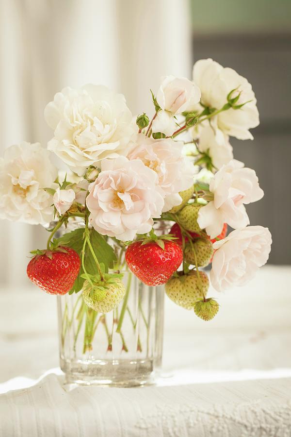 Summer Bouquet Of White Garden Roses And Sprigs Of Strawberries In Glass Vase Photograph by Sibylle Pietrek