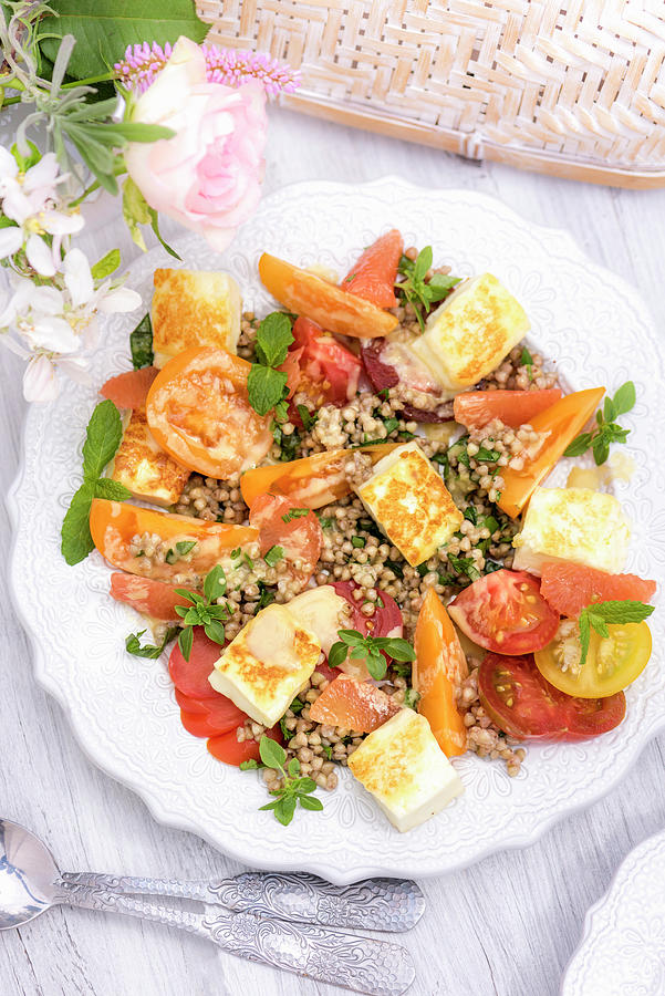 Summer Buckwheat Salad With Tomatoes And Halloumi On A Table Outside Photograph by Winfried Heinze