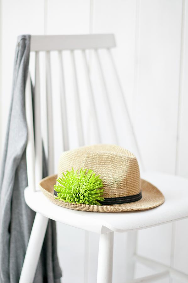 Summer Hat With Green Chrysanthemum anastasia In Hat Band On White Wooden Chair Photograph by Cornelia Weber