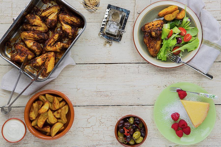Summer Lunch Of Chicken Wings, Potato Wedges, Olives And Salad With Lemon Tart And Fresh Raspberries For Dessert Photograph by Artfeeder