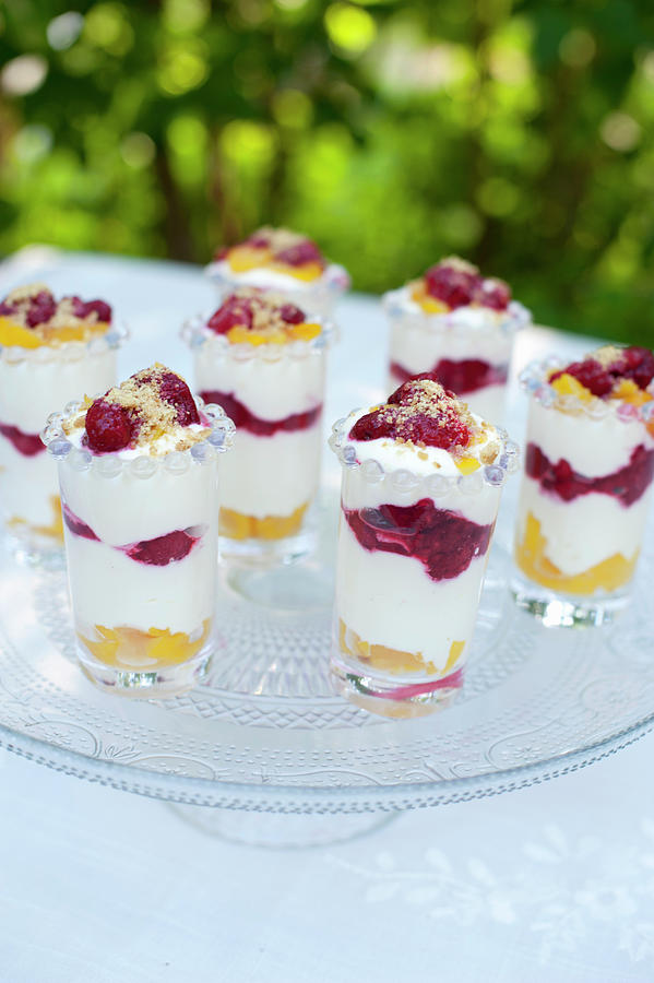 Summery Layered Desserts With Peaches And Raspberries On An Outdoor Table Photograph by Magdalena Bjrnsdotter