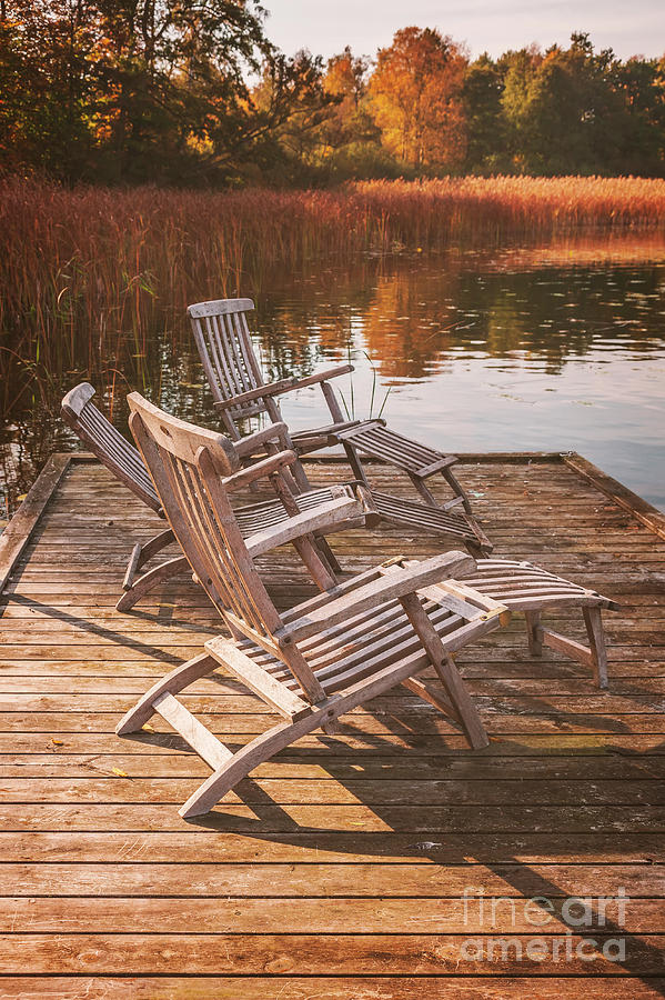 Sun loungers by lake Photograph by Sophie McAulay