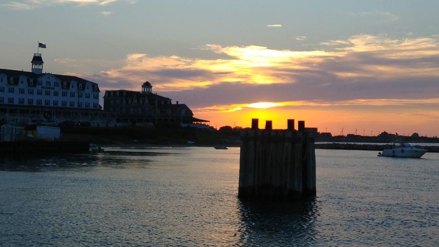 Sun setting over Block Island Rhode Island Photograph by Patricia Caron