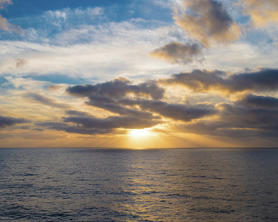 Sun shining through some Clouds prior to Sunset at Sea Photograph by William Dickman
