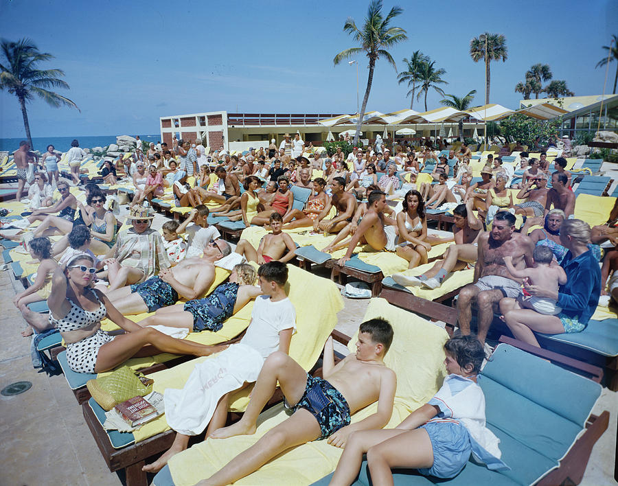 Travel Photograph - Sunbathing At The Americana Hotel by Hank Walker