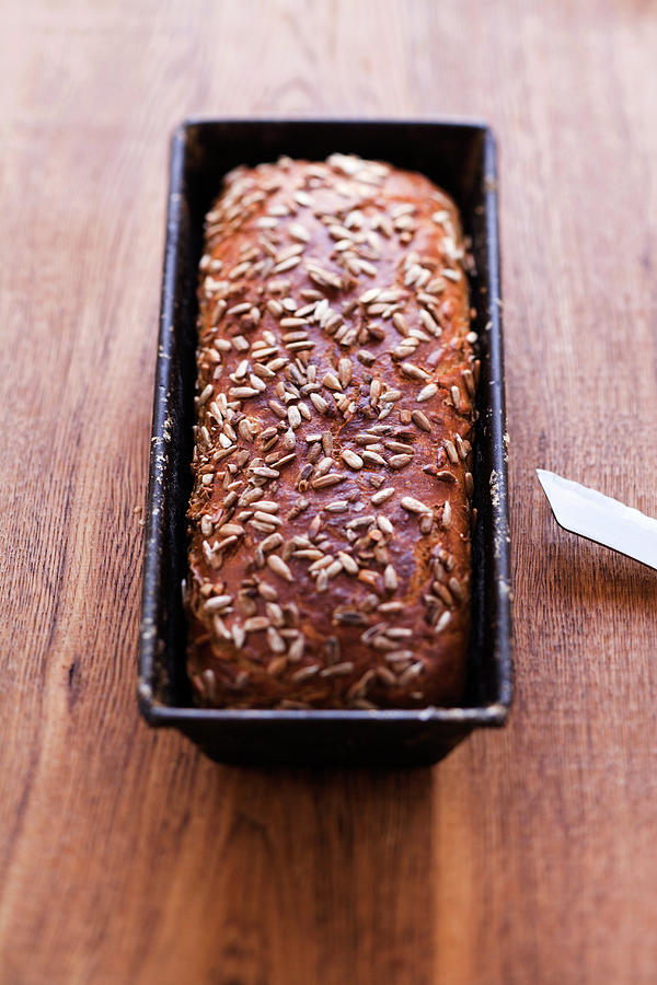 Sunflower Seed Bread In A Loaf Tin Photograph by Michael Wissing
