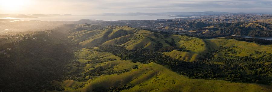 Nature Photograph - Sunlight Illuminates The Green Hills by Ethan Daniels