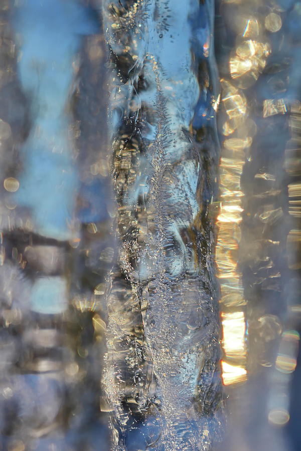 Sunlight is shining through a row of icicles Photograph by Intensivelight
