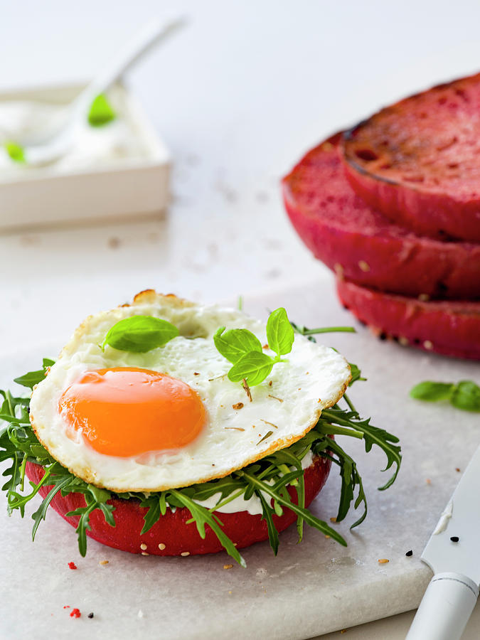 Sunny Side Up With Rucola On A Beet Bread Bun Photograph by Vulman Pter