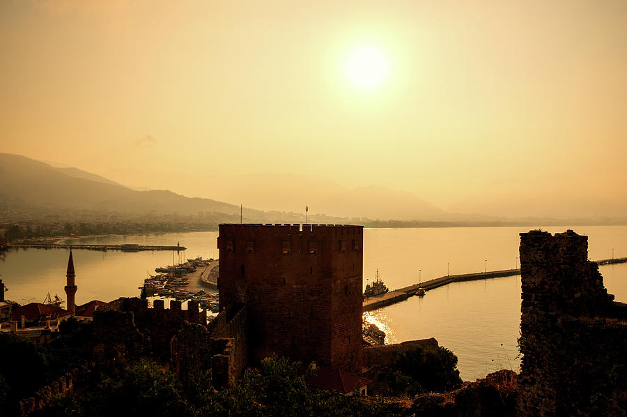 Sunrise above the red tower of Alanya Photograph by Sun Travels
