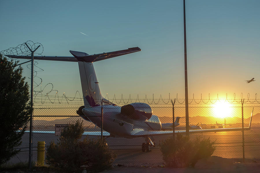 Las Vegas Photograph - Sunrise At The Airport With Barbed Wire Security Fence And Jetli by Alex Grichenko