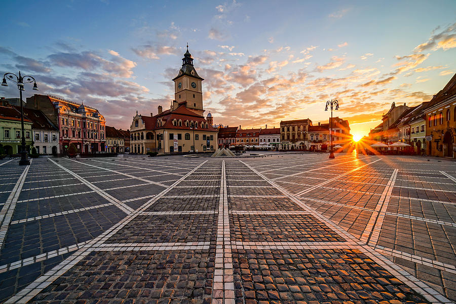 Sunset Photograph - Sunrise in the city of Brasov in Transylvania, Romania. by George Afostovremea