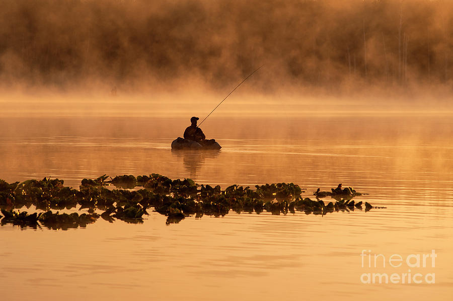 Sunrise on Lake Cassidy with Fisherman  Photograph by Jim Corwin