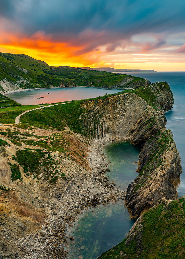Sunrise on the Jurassic coast at Lulworth cove in England Photograph by George Afostovremea
