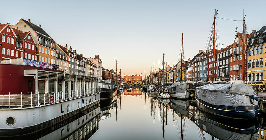 Sunrise over the calm water at Nyhavn harbor in Copenhagen, Feb ...