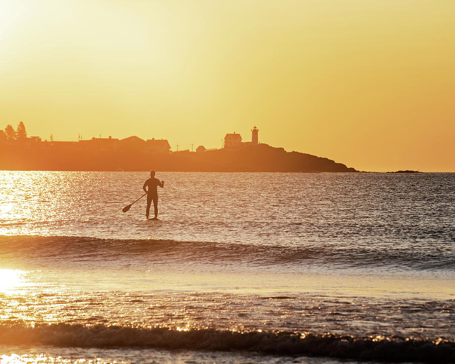 Sunrise Paddle Boarder Paddling by the Nubble Lighthouse from Long Sands Beach Long Beach York Maine Photograph by Toby McGuire